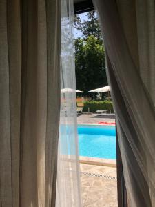 a view of a swimming pool through a window at Il Capisterium in Norcia