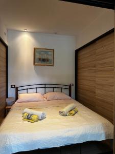 a bedroom with a large bed with two pillows on it at Amélie in Mošćenička Draga