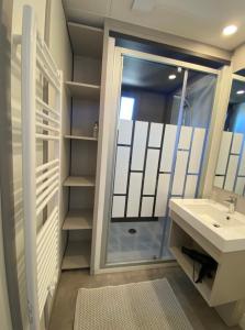 a bathroom with a sink and a shower at Cottage "SANS SOUCI" chaleureux à 150m de la plage in Jullouville-les-Pins