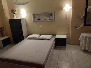 een slaapkamer met een bed en een dressoir bij Sunny inside out in Áyios Pávlos