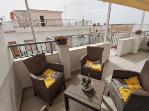 a balcony with two chairs and a table on a building at Mary Vi Rooms in Peschici