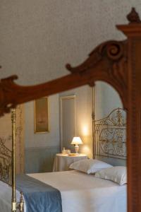 a bedroom with a bed with a wooden frame at Villa Fenicia in Ruvo di Puglia