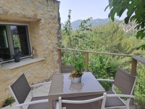 a table and chairs on a balcony with a view at Domaine luna estella in Tourrette-Levens