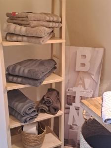 a stack of towels on shelves in a room at Domaine luna estella in Tourrette-Levens +12 photos