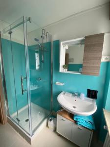 a bathroom with a glass shower and a sink at Chez Carlo 2.0 in Aosta