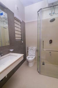 a bathroom with a toilet and a sink and a shower at Bluewind Luxury Apartment - 2rooms - Wattala-Hemas Hospital in Wattala