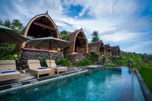 a villa with a swimming pool and a resort at Lumbung Seraya Villa in Karangasem