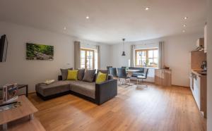 a living room with a couch and a table at Haus Klingenschmid in Hopfgarten im Brixental