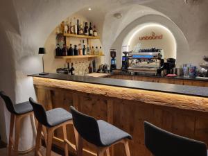a bar with chairs and a counter in a room at Wohnung Panoramablick in Seefeld in Tirol