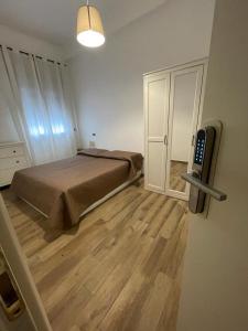 1 dormitorio con 1 cama y TV en la pared en La TERRAZZA, en Nunziata