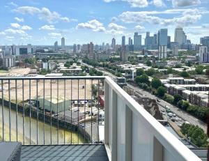 a view of a city from the balcony of a building at Stunning property with London city and river views in London