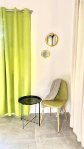 a chair and a table and a green curtain at Sharma Costa Rica - Heliconia Casita in Uvita