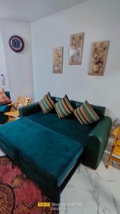 a green couch sitting in a living room at Porto said in Port Said