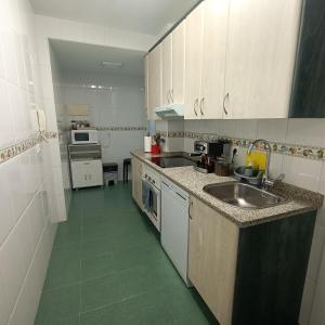 a small kitchen with a sink and a stove at Luxury Family Homes M in Salamanca