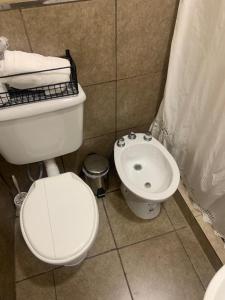 a bathroom with a toilet and a sink at Departamentos Cristo del Portezuelo in Chilecito