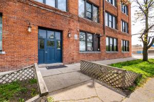 a brick building with a blue door on it at 420 Friendly Loft Skyline/Canada View Free Parking in Detroit