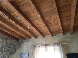 a room with wooden ceilings and a window at Appartamento Il Vicoletto in La Spezia