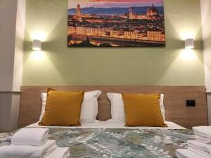 Postel nebo postele na pokoji v ubytování Hotel Camilla Guelfa