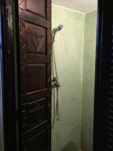 a bathroom with a shower next to a door at Nour Mogador in Ghazoua