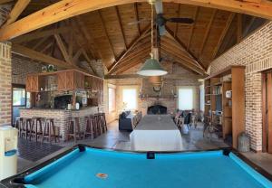 a living room with a pool table in it at Casa de campo en club privado Benquerencia in San Miguel del Monte