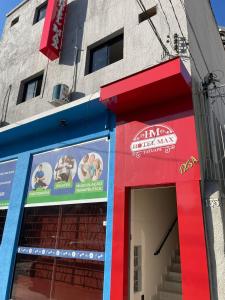 a building with a red and blue entrance to a restaurant at Hotel Max Tatuapé in Sao Paulo