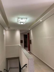 a hallway with a stair case in a building at Hotel Max Tatuapé in São Paulo