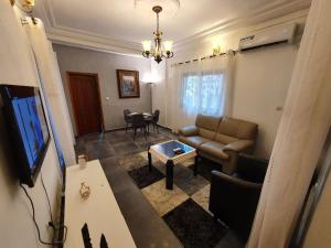 a living room with a couch and a table at Résidence M Douala in Douala