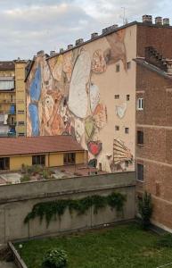 a large mural on the side of a building at La Casa di Nora in Turin
