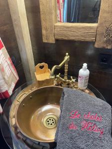 a bathroom sink with a towel on it at Le chalet du Hélivy in Jalhay