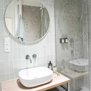 a bathroom with a white sink and a shower at Stilvolle Stadtoase in Brno