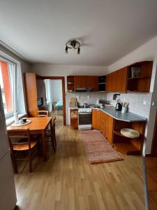 a kitchen with a table and a dining room at Apartmán MW in Poprad