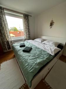 a bedroom with a large bed with a window at Apartmán MW in Poprad