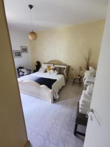 a bedroom with a large bed with a tiled floor at Mountain View House in San Cassiano