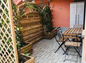 a patio with a wooden fence and a table and chairs at Casa Macrino Apartment Alba in Alba