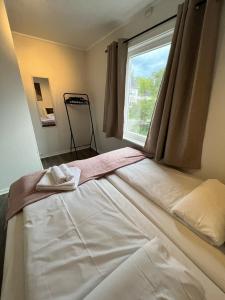 a bed in a room with a window at Central trainstation apartment in Narvik