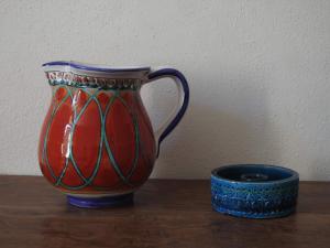 a vase sitting on a table next to a cup at Casa Francesca, vicino al mare in Sestri Levante