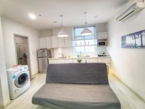 a kitchen with a bed in the middle of a room at Deluxe Suites 2, Netflix ,2-5 pax, Georgetown in George Town