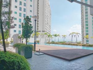 a pool in the middle of a city with tall buildings at Deluxe Suites 2, Netflix ,2-5 pax, Georgetown in George Town
