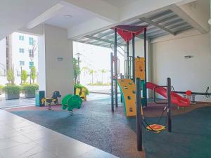 a play room with a playground with a slide at Deluxe Suites 2, Netflix ,2-5 pax, Georgetown in George Town