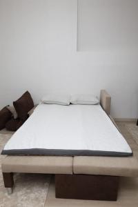 una cama sentada en una habitación al lado en Gramosli Apartment, en Bitola