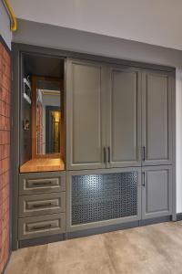 a bathroom with white cabinets and a mirror at Sofyapart in Soğuksu