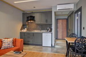 a kitchen and living room with a couch and a table at Sofyapart in Soğuksu