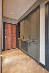 a kitchen with gray cabinets and a garage door at Sofyapart in Soğuksu