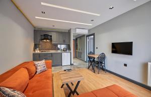 a living room and kitchen with a couch and a table at Sofyapart in Soğuksu