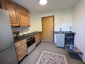 a kitchen with wooden cabinets and a sink at Ferientreff-Stilfs in Stelvio