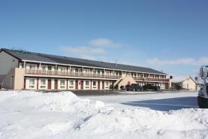 a building with a lot of snow in front of it at Lake Erie Lodge in Lakemont Landing