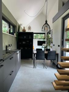 a kitchen with a table and a dining room at It Skoft in Siegerswoude