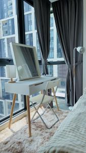 a laptop computer sitting on a desk in front of a window at TheOoak suite 4pax cozy home stay @mont kiara in Kuala Lumpur +74 photos