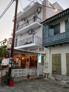 a white building with a balcony on the side of it at Sea View in Loutraki