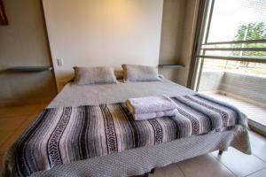 a bedroom with a bed with two pillows and a window at Espectacular Loft a estrenar !! in Godoy Cruz